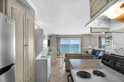 a kitchen and living room with a view of the ocean at Summit 807 Beach Resort - Amazing Balcony Views in Panama City Beach
