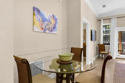 a dining room with a glass table and chairs at 30A-Sea La Vie-Seagrove Highlands 2302 in Santa Rosa Beach