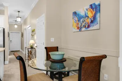 a dining room with a glass table and chairs at 30A-Sea La Vie-Seagrove Highlands 2302 in Santa Rosa Beach