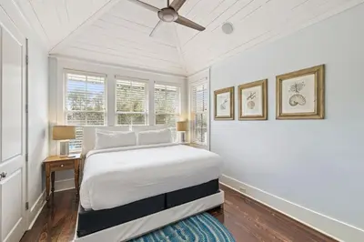 a bedroom with a bed and a ceiling fan at Sea Glass Cottage by 30A Escapes in Watersound Beach