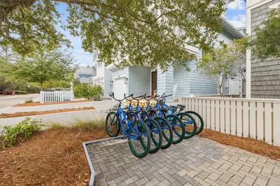a row of blue bikes parked next to a house at Sea Glass Cottage by 30A Escapes in Watersound Beach