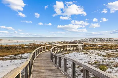 a wooden boardwalk leading to the beach at Sea Glass Cottage by 30A Escapes in Watersound Beach