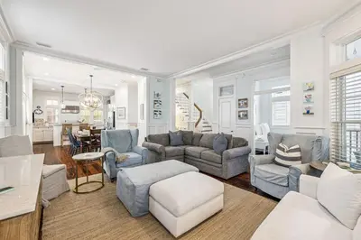 a living room with a couch and chairs and a table at Sea Glass Cottage by 30A Escapes in Watersound Beach