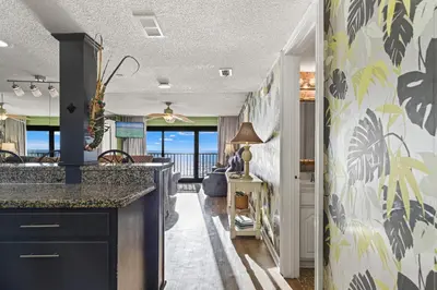 a kitchen with a view of the ocean at Commodore 0601 in Panama City Beach