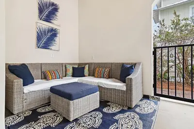a living room with two wicker chairs and a couch at Villa Palmeira in Santa Rosa Beach