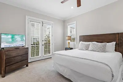 a bedroom with a bed and a flat screen tv at Villa Palmeira in Santa Rosa Beach