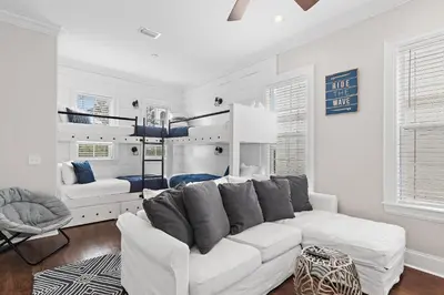 a white living room with a white couch and a bed at Villa Palmeira in Santa Rosa Beach