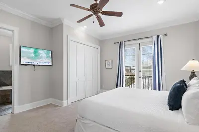 a bedroom with a bed and a ceiling fan at Villa Palmeira in Santa Rosa Beach