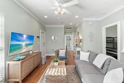 a living room with a couch and a flat screen tv at Beach Therapy in Seacrest