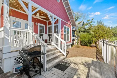 a house with a grill on the front porch at Beach Therapy in Seacrest