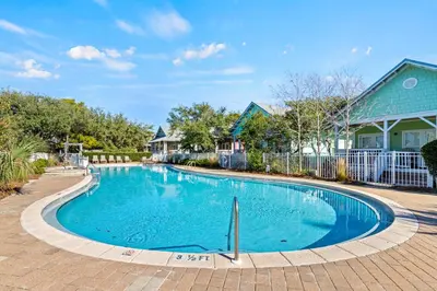 a swimming pool in a yard with a house at Beach Therapy in Seacrest
