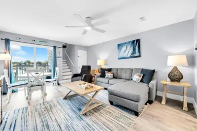 a living room with a couch and a table at Lullwater Beach 415 in Panama City Beach