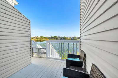 a balcony with two chairs and a view of the water at Lullwater Beach 415 in Panama City Beach