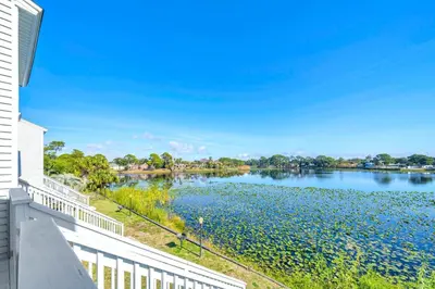 a view of a lake from the balcony of a house at Lullwater Beach 415 in Panama City Beach