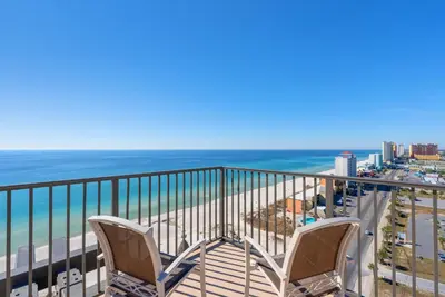 a balcony with two chairs and the ocean at Origin 1602 -PENTHOUSE- 3 Bedroom- Sweeping Gulf in Panama City Beach
