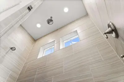 a bathroom with a shower with two windows at Rhema Luxury Beach Haus 2BR 2B ResortPool with optional 6-seater GolfCart & 4Bikes in Inlet Beach