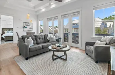 a living room with a couch and a table at Rhema Luxury Beach Haus 2BR 2B ResortPool with optional 6-seater GolfCart & 4Bikes in Inlet Beach