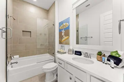 a bathroom with a sink and a toilet and a mirror at Rhema Luxury Beach Haus 2BR 2B ResortPool with optional 6-seater GolfCart & 4Bikes in Inlet Beach