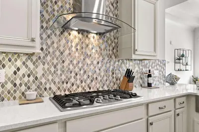 a kitchen with a stove top oven in a kitchen at Rhema Luxury Beach Haus 2BR 2B ResortPool with optional 6-seater GolfCart & 4Bikes in Inlet Beach