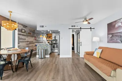 a living room with a couch and a table at PCB Beach Gateaway On The Sand in Panama City Beach