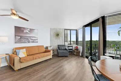 a living room with a couch and a table at PCB Beach Gateaway On The Sand in Panama City Beach