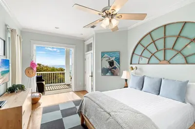 a bedroom with a bed and a ceiling fan at High Tide in Inlet Beach