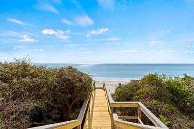 a wooden staircase leading down to the beach at High Tide in Inlet Beach