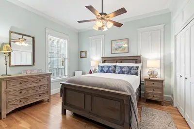 a bedroom with a bed and a ceiling fan at High Tide in Inlet Beach