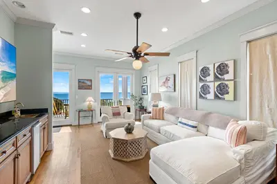 a living room with a couch and a table at High Tide in Inlet Beach