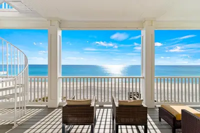 a balcony with chairs and a view of the ocean at High Tide in Inlet Beach