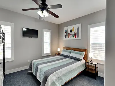 a bedroom with a bed and a ceiling fan at Nothin But Time in Panama City Beach