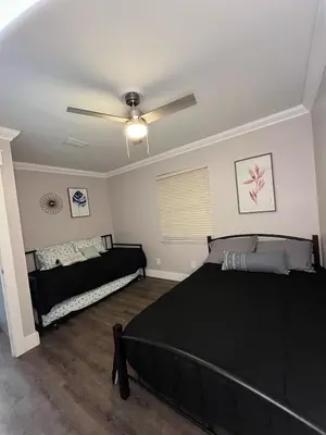 a bedroom with two beds and a ceiling fan at Renovated Townhome by the Bay in Panama City