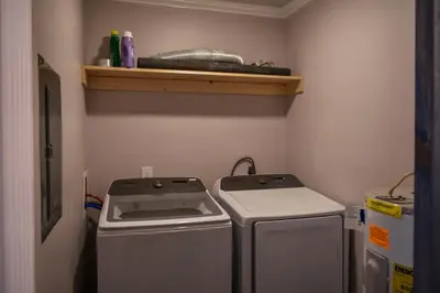 a small kitchen with two machines and a shelf at Renovated Townhome by the Bay in Panama City