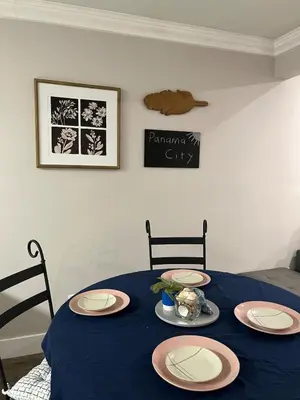 a table with a blue table cloth and plates on it at Renovated Townhome by the Bay in Panama City