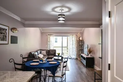 a living room with a table and a couch at Renovated Townhome by the Bay in Panama City