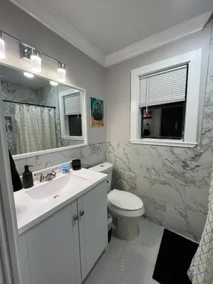a bathroom with a sink and a toilet and a mirror at Renovated Townhome by the Bay in Panama City