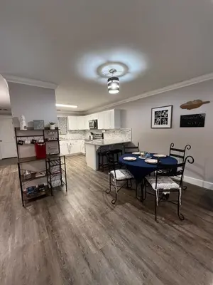 a living room with a table and chairs and a kitchen at Renovated Townhome by the Bay in Panama City