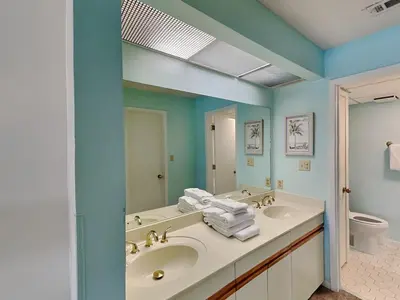 a bathroom with two sinks and a mirror at Edgewater Villa #2713 - The Palm and Pool Villa in Panama City Beach