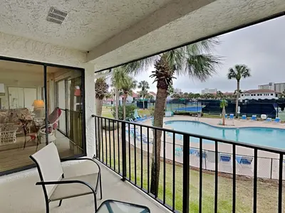 a balcony with a view of a swimming pool at Edgewater Villa #2713 - The Palm and Pool Villa in Panama City Beach
