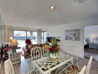 a living room with a couch and a table at Edgewater Villa #2713 - The Palm and Pool Villa in Panama City Beach