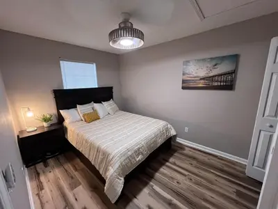 a bedroom with a bed and a pendant light at First Cast in Panama City Beach