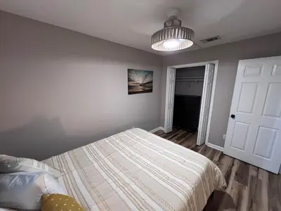 a bedroom with a bed and a pendant light at First Cast in Panama City Beach