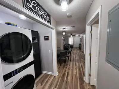 a hallway with a living room with a microwave at First Cast in Panama City Beach
