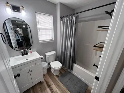 a bathroom with a toilet and a sink and a mirror at First Cast in Panama City Beach