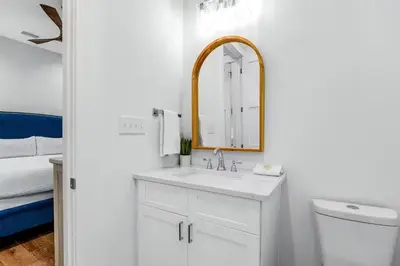 a white bathroom with a sink and a mirror at Sunny Side Up by Travel Life Vacations in Santa Rosa Beach