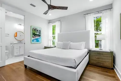 a white bedroom with a bed and a bathroom at Sunny Side Up by Travel Life Vacations in Santa Rosa Beach