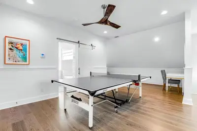 a ping pong table in a room with a ceiling at Sunny Side Up by Travel Life Vacations in Santa Rosa Beach