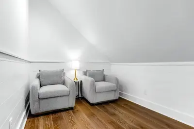two chairs and a lamp in a room with white walls at Sunny Side Up by Travel Life Vacations in Santa Rosa Beach