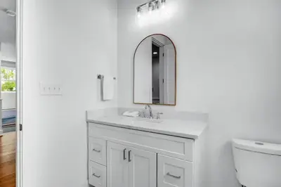 a white bathroom with a sink and a mirror at Sunny Side Up by Travel Life Vacations in Santa Rosa Beach