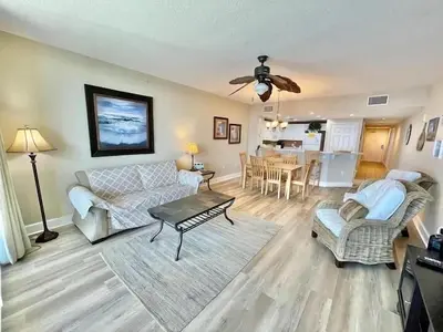 a living room with a couch and a table at Majestic Beach Towers 2-2107 by Emerald Coast Retreats in Panama City Beach